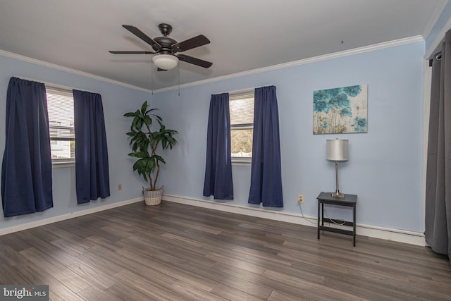 unfurnished room with a wealth of natural light, a ceiling fan, and wood finished floors