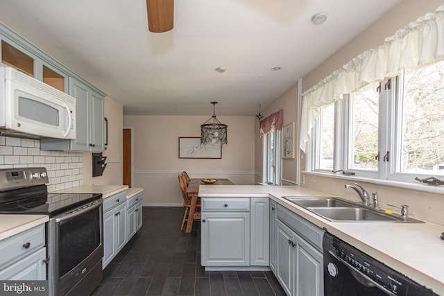 kitchen with gray cabinets, stainless steel electric range, white microwave, backsplash, and dishwasher