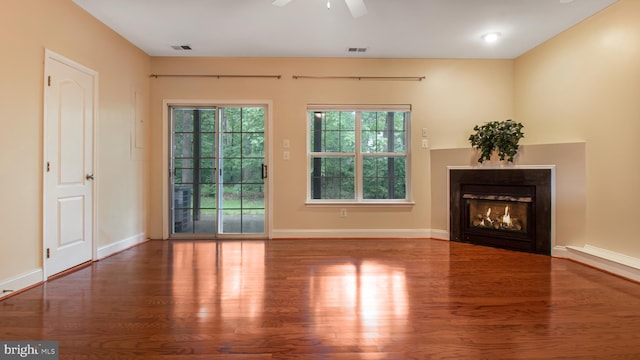 2080 Capstone Cir, Herndon, VA 20170 - unfurnished living room with wood finished floors, a ceiling fan, a glass covered fireplace, and baseboards