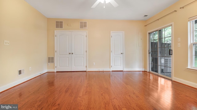 2080 Capstone Cir, Herndon, VA 20170 - unfurnished bedroom featuring wood finished floors, baseboards, access to exterior, and ceiling fan