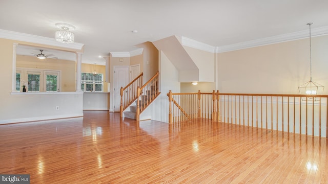 2080 Capstone Cir, Herndon, VA 20170 - unfurnished living room featuring a chandelier, ornamental molding, ceiling fan, wood finished floors, and baseboards
