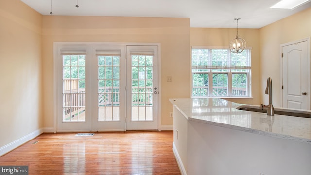 2080 Capstone Cir, Herndon, VA 20170 - doorway with light wood-type flooring, plenty of natural light, and baseboards