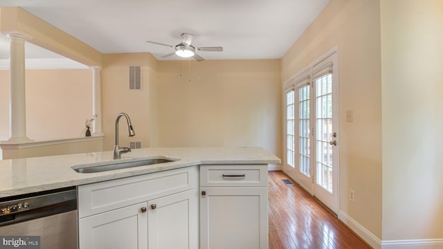 2080 Capstone Cir, Herndon, VA 20170 - kitchen with stainless steel dishwasher, a sink, a ceiling fan, and light stone countertops
