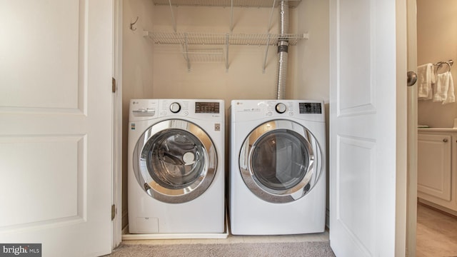 2080 Capstone Cir, Herndon, VA 20170 - laundry area featuring washing machine and clothes dryer and light tile patterned floors