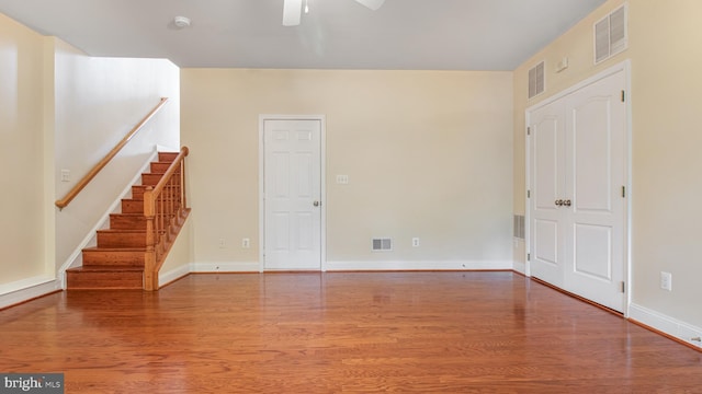 2080 Capstone Cir, Herndon, VA 20170 - spare room featuring wood finished floors, stairway, a ceiling fan, and baseboards