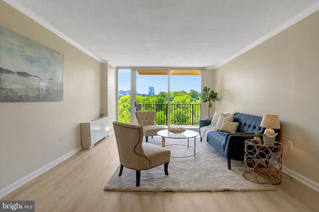 living area with baseboards, floor to ceiling windows, ornamental molding, and wood finished floors