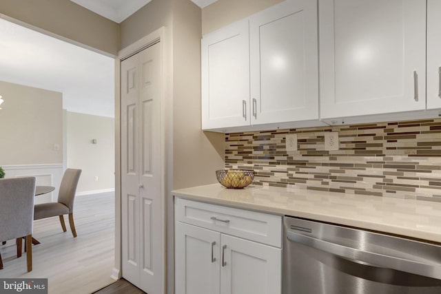 bar with wood finished floors, decorative backsplash, and dishwasher