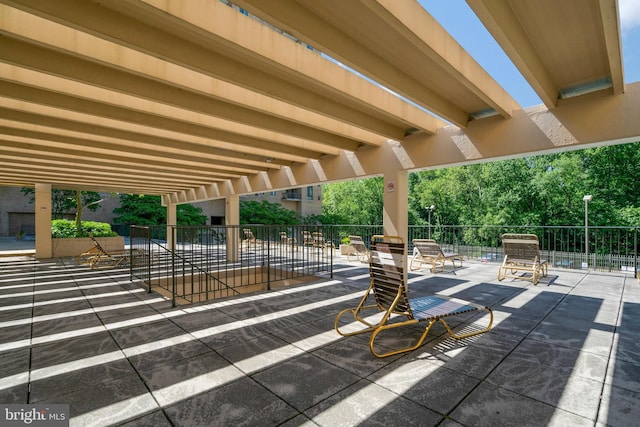 view of patio featuring fence