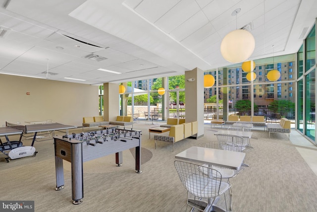game room with carpet floors, expansive windows, and visible vents