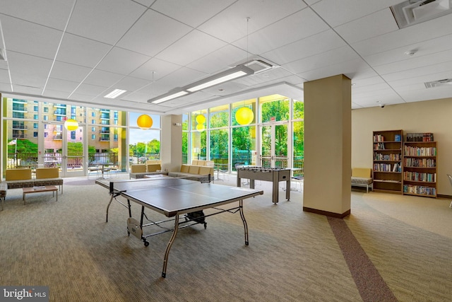 recreation room with visible vents, carpet flooring, and a wall of windows