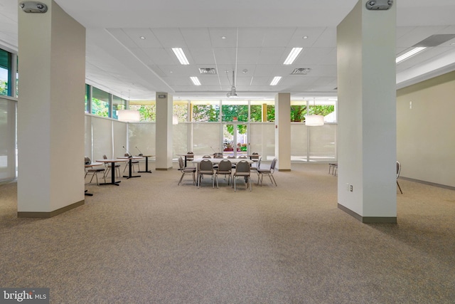 dining space with carpet floors, visible vents, baseboards, and a paneled ceiling