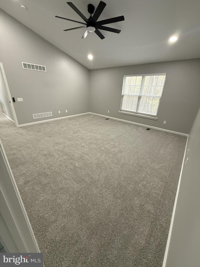 carpeted spare room featuring visible vents, baseboards, a ceiling fan, and recessed lighting