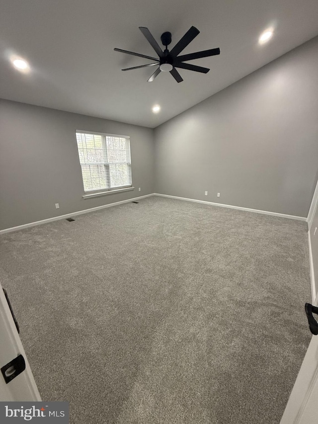 carpeted spare room featuring visible vents, ceiling fan, recessed lighting, and baseboards