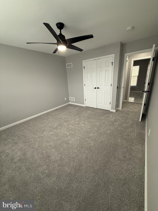 unfurnished bedroom with visible vents, baseboards, a closet, and carpet floors