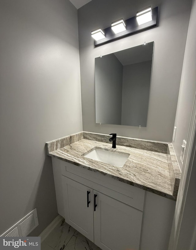 bathroom with vanity, marble finish floor, and visible vents