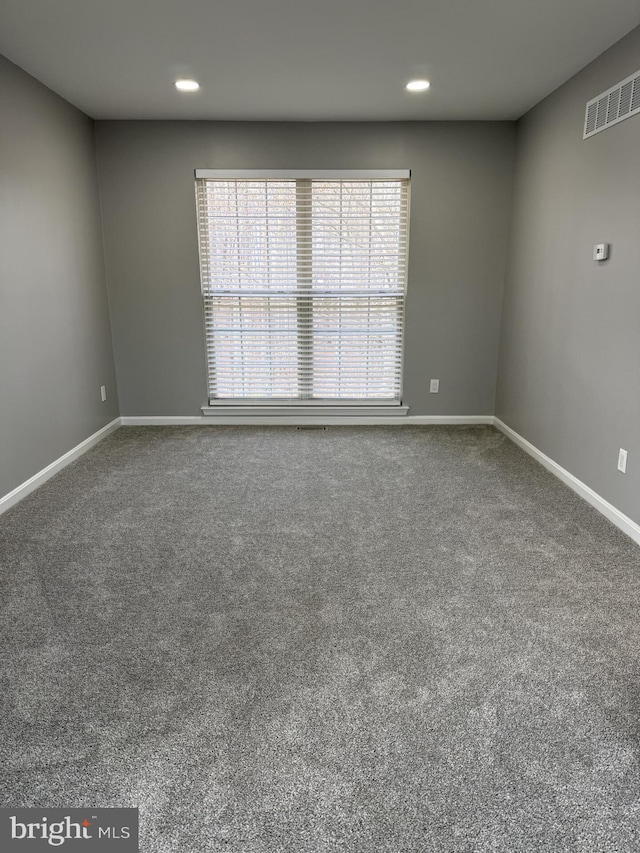 spare room with visible vents, baseboards, recessed lighting, and carpet flooring
