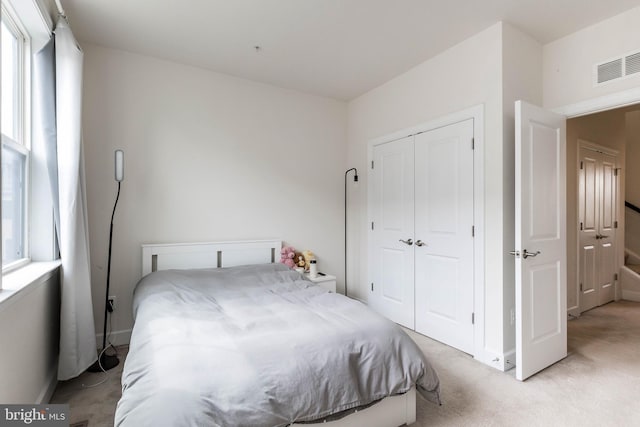 6645 Rhode Island Ave, Riverdale, MD 20737 - bedroom with a closet, baseboards, visible vents, and light colored carpet