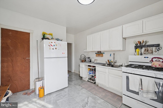 kitchen with a sink, light countertops, marble finish floor, white appliances, and white cabinetry