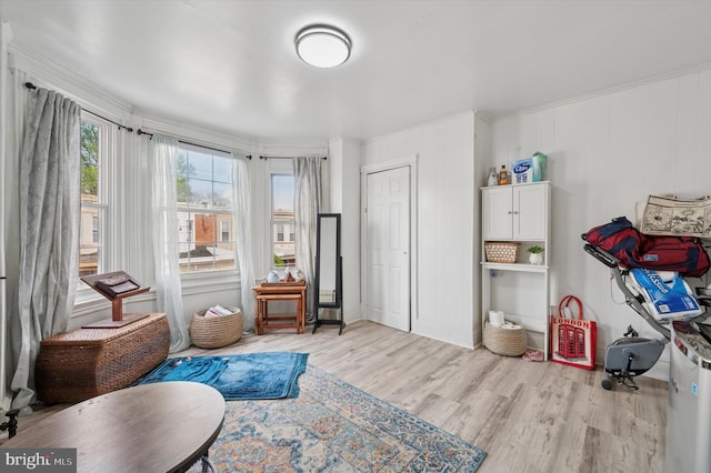 sitting room featuring light wood-style floors and ornamental molding