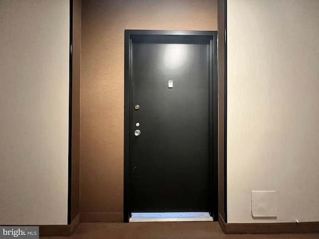 doorway to outside with baseboards