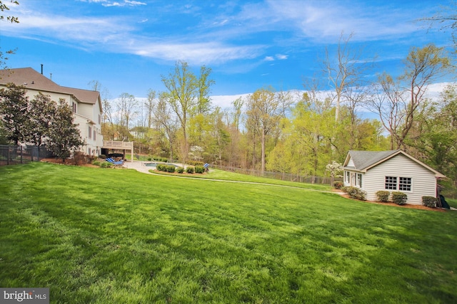 view of yard featuring a deck and fence
