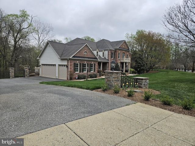 craftsman-style home featuring brick siding, a front lawn, an attached garage, and aphalt driveway