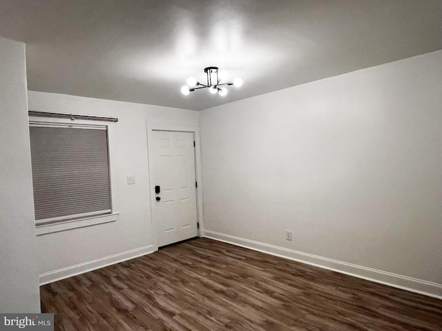 1447 Holbrook St NE, Washington, DC 20002 - spare room featuring a chandelier, dark wood finished floors, and baseboards