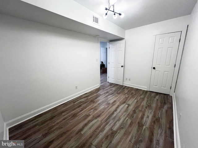 1447 Holbrook St NE, Washington, DC 20002 - unfurnished bedroom featuring dark wood finished floors, baseboards, and a chandelier