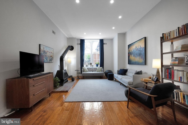 living room with recessed lighting, light wood-type flooring, and visible vents