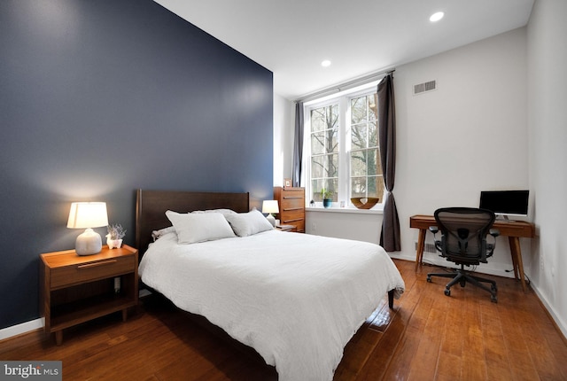 bedroom with recessed lighting, baseboards, visible vents, and wood finished floors
