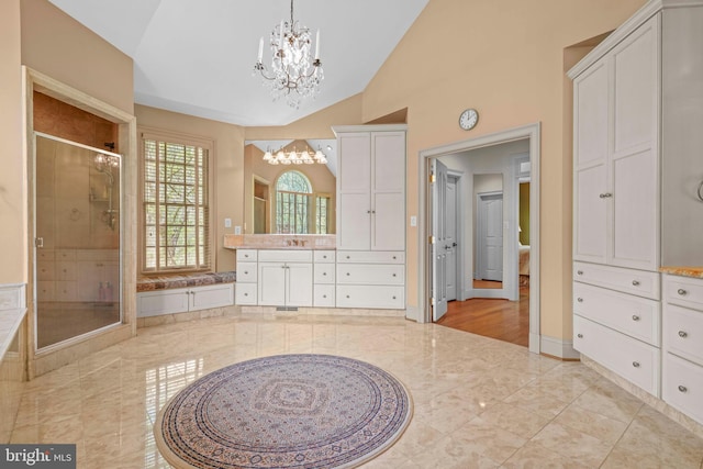 full bathroom featuring a shower stall, a bath, vanity, lofted ceiling, and a notable chandelier