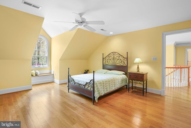 bedroom featuring wood finished floors, visible vents, and baseboards