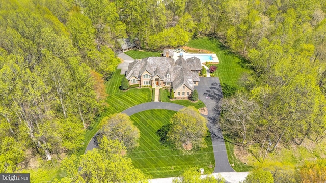 birds eye view of property with a forest view