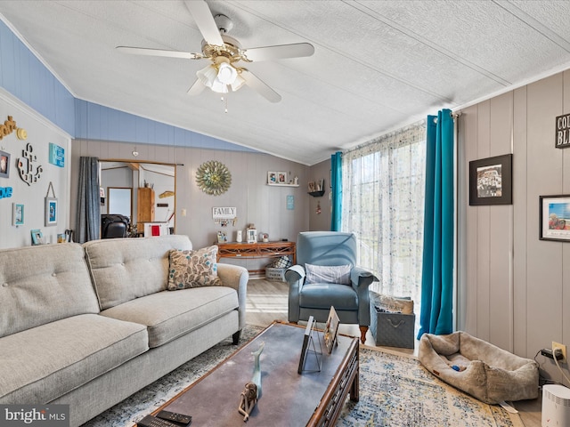 27689 Hartford Ct, Millsboro, DE 19966 - living room featuring ceiling fan, vaulted ceiling, wood finished floors, and a textured ceiling