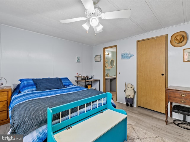 27689 Hartford Ct, Millsboro, DE 19966 - bedroom featuring connected bathroom, ceiling fan, and light wood-style floors
