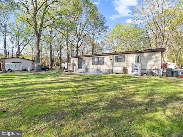 27689 Hartford Ct, Millsboro, DE 19966 - rear view of property featuring a lawn, entry steps, and heating fuel