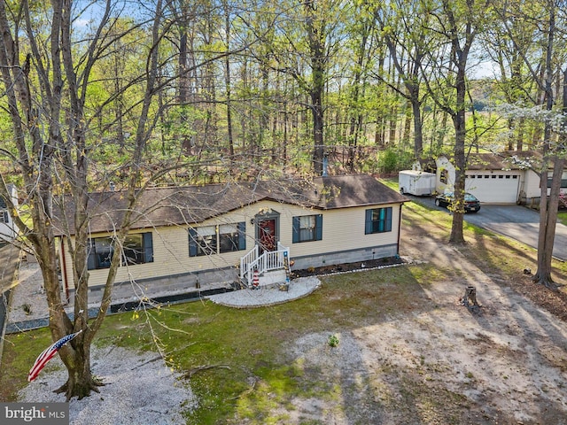 27689 Hartford Ct, Millsboro, DE 19966 - manufactured / mobile home with concrete driveway, crawl space, roof with shingles, and a garage