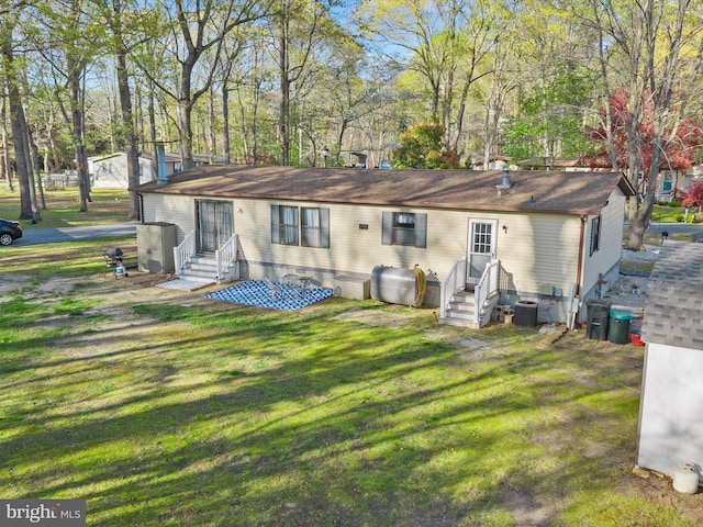 27689 Hartford Ct, Millsboro, DE 19966 - rear view of house featuring cooling unit, heating fuel, entry steps, a yard, and crawl space