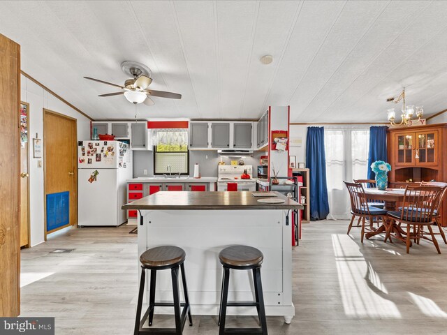27689 Hartford Ct, Millsboro, DE 19966 - kitchen with ceiling fan with notable chandelier, white appliances, a sink, and a healthy amount of sunlight