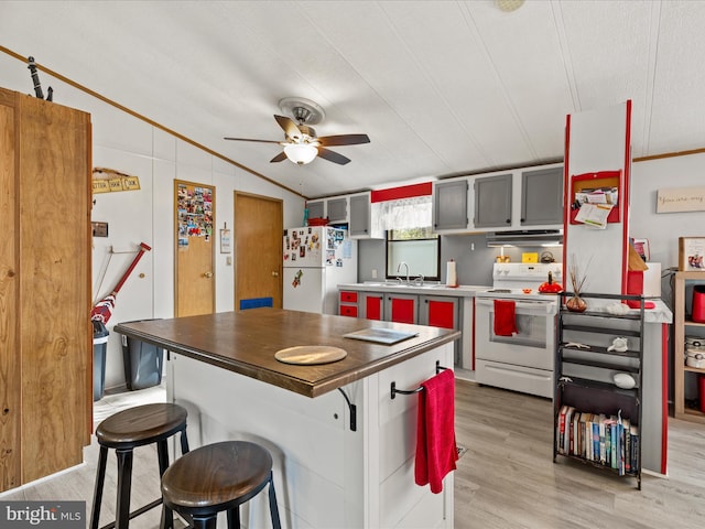 27689 Hartford Ct, Millsboro, DE 19966 - kitchen with light wood-style floors, a breakfast bar, white appliances, ceiling fan, and ornamental molding