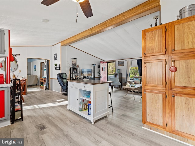 27689 Hartford Ct, Millsboro, DE 19966 - kitchen featuring dark countertops, open shelves, vaulted ceiling with beams, ceiling fan, and light wood-style flooring