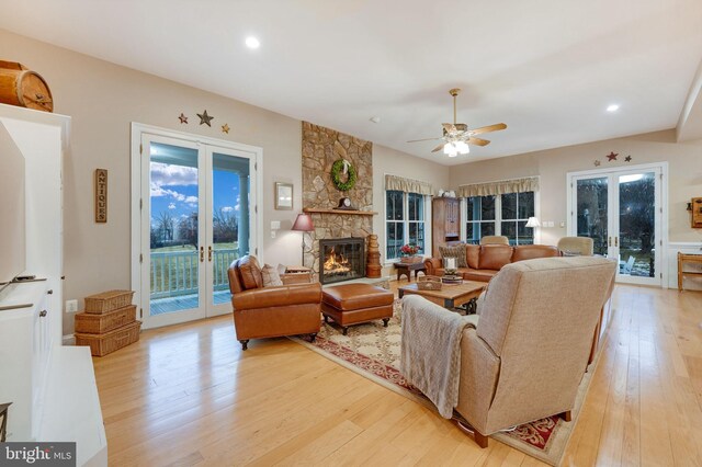 34844 Apple Pride Ct, Round Hill, VA 20141 - living room with a stone fireplace, a healthy amount of sunlight, light wood finished floors, and french doors