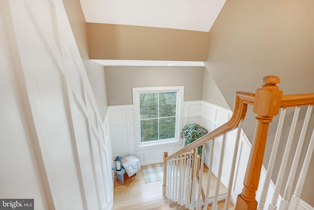 34844 Apple Pride Ct, Round Hill, VA 20141 - stairway featuring wainscoting, a decorative wall, and wood finished floors