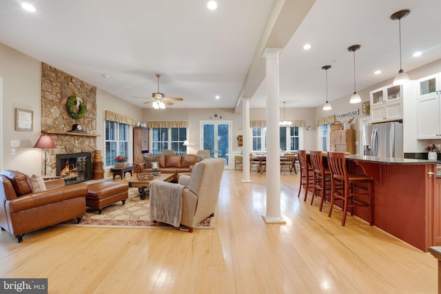 34844 Apple Pride Ct, Round Hill, VA 20141 - living area featuring light wood-style flooring, a fireplace, decorative columns, ceiling fan, and recessed lighting