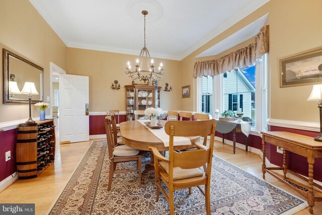 34844 Apple Pride Ct, Round Hill, VA 20141 - dining space featuring crown molding, light wood-style flooring, and a notable chandelier