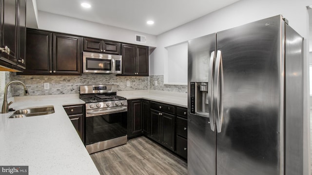 11400 Cosca Park Pl, Clinton, MD 20735 - kitchen with tasteful backsplash, light wood-style flooring, visible vents, appliances with stainless steel finishes, and a sink
