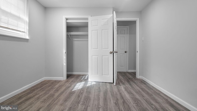 11400 Cosca Park Pl, Clinton, MD 20735 - unfurnished bedroom with a closet, baseboards, and wood finished floors