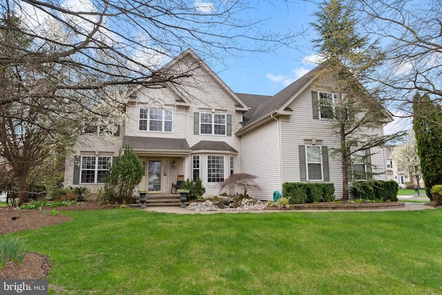 traditional home with roof with shingles and a front lawn