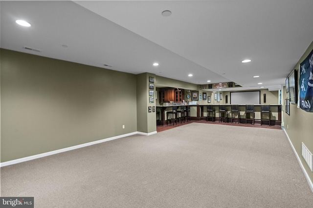 interior space featuring wet bar, carpet, and recessed lighting