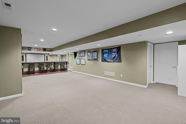 finished basement featuring recessed lighting, visible vents, and carpet floors